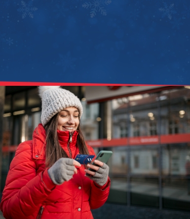 Women in winter clothes looking at her Manasquan Bank Mastercard card